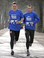 Two men running as pair